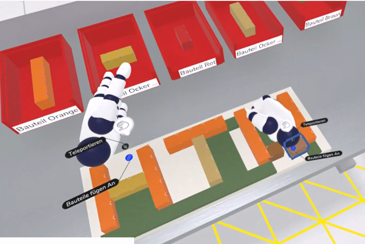 virtuell dargestellte Hände legen ordnen Bauteile auf einem Montagetisch an