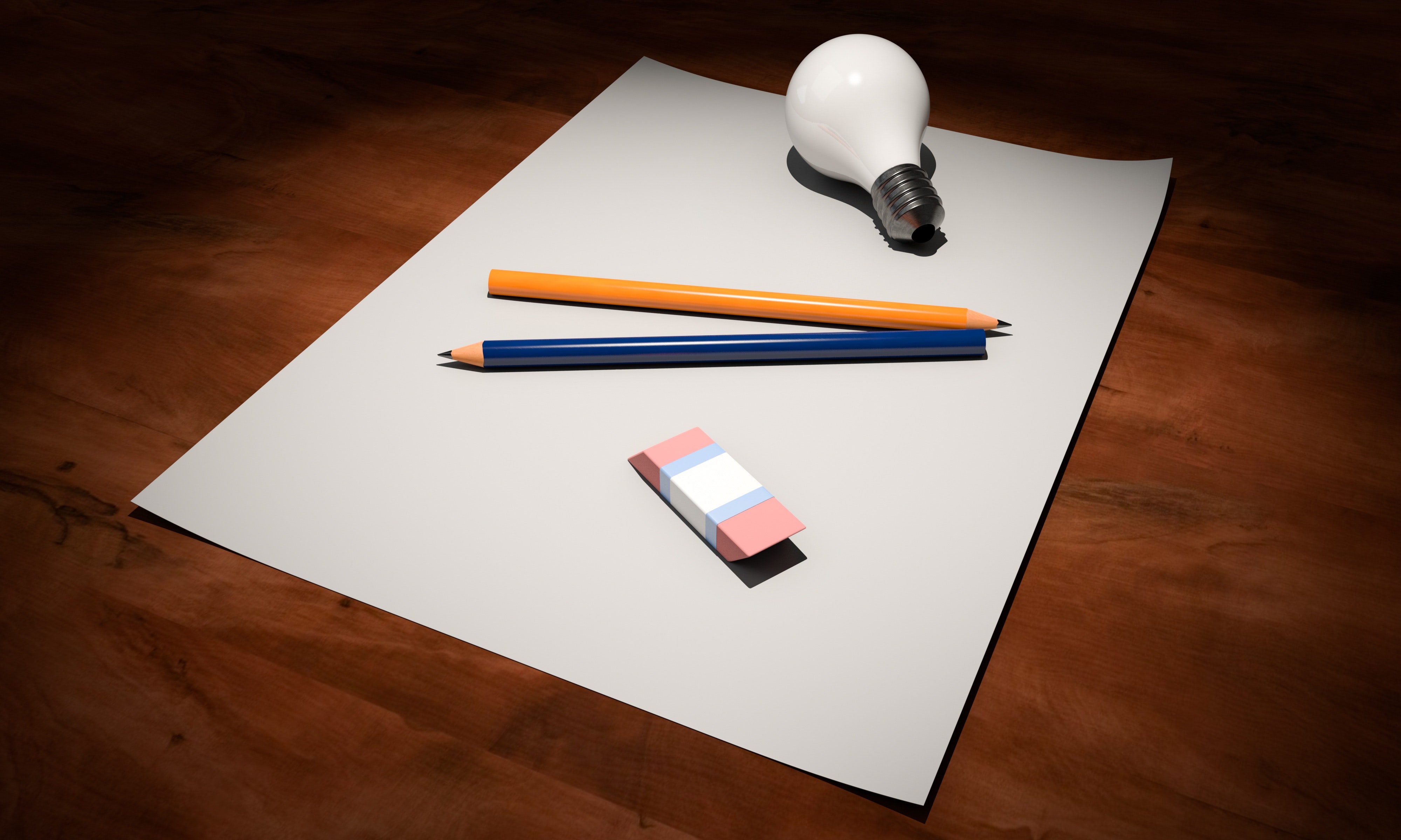 pencils and a lightbulb on a desk