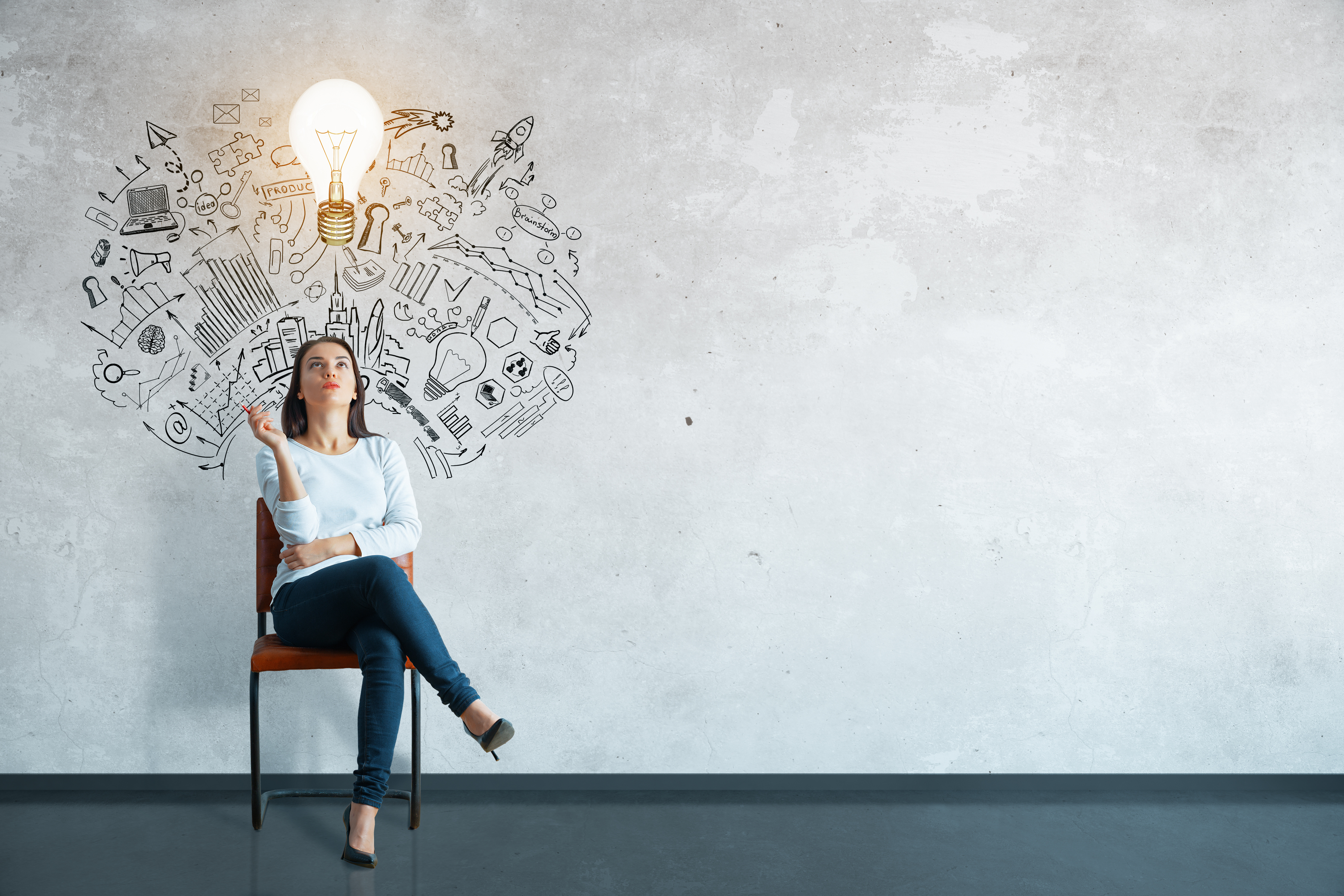 Adobestock/peshkova A woman is sitting on a chair. There is a light bulb above her head.