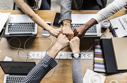 Teamarbeit von Menschen am Schreibtisch mit Laptop