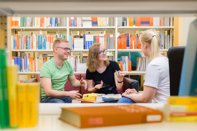 Students at the table in the library