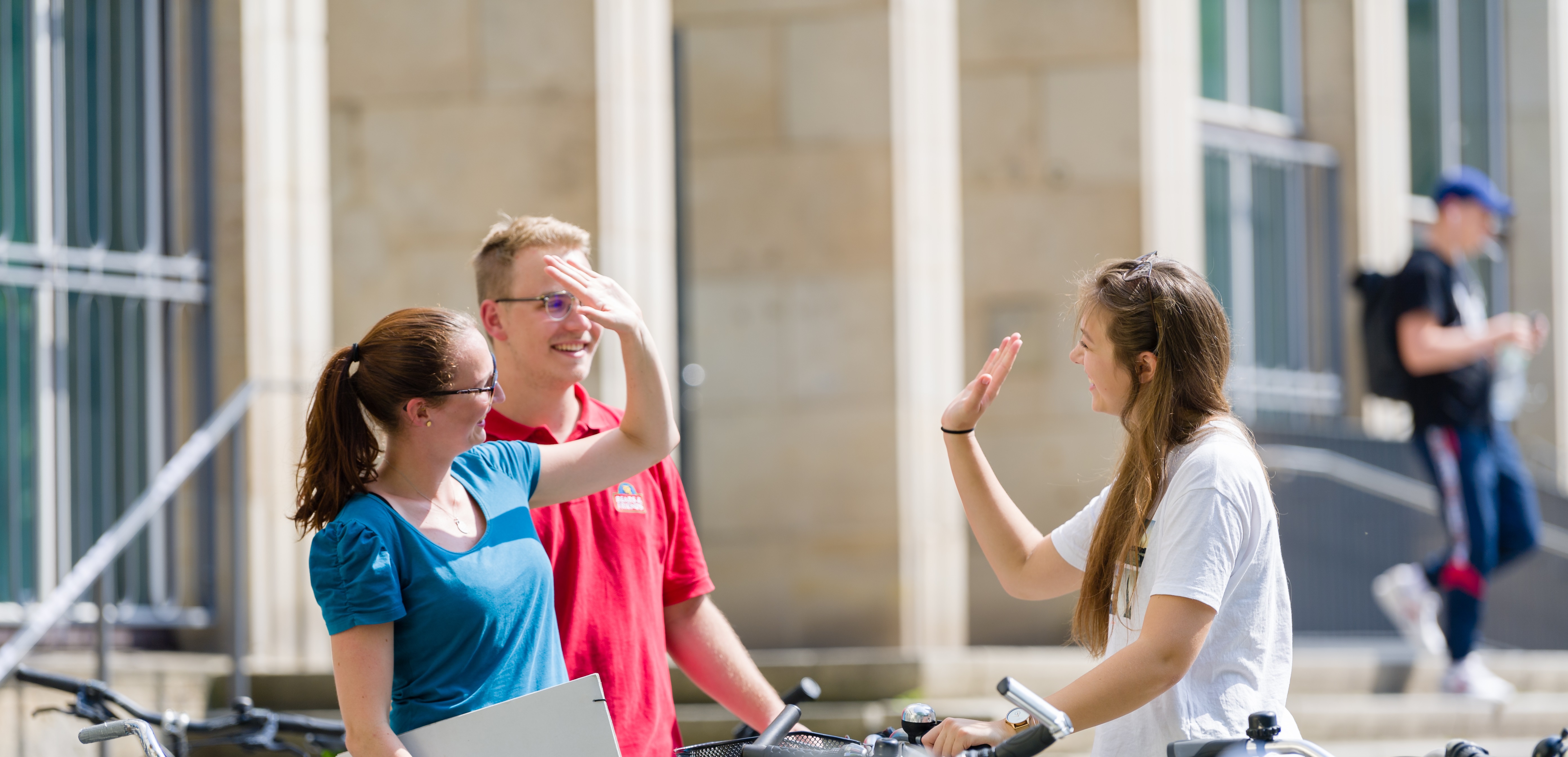 Students greet each other in front of the central building