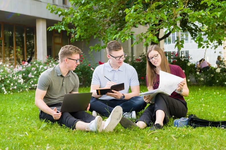 Students sit in the rose garden