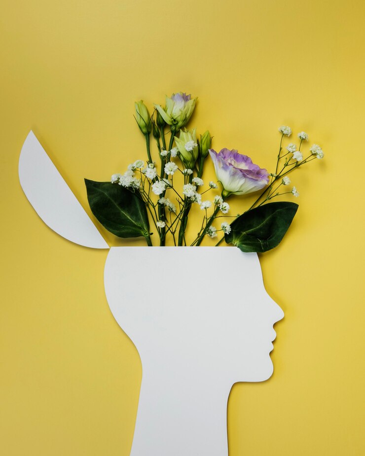 Scherenschnittbüste mit Blumen die aus dem Kopf kommen