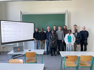 A group of people in front of a blackboard