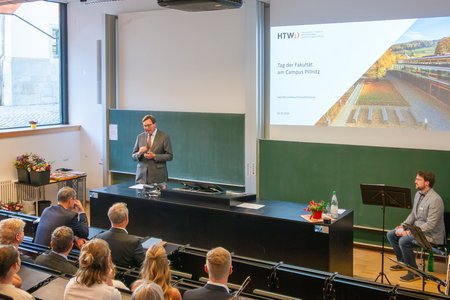 Ein Mann, der vor einem Publikum redet.