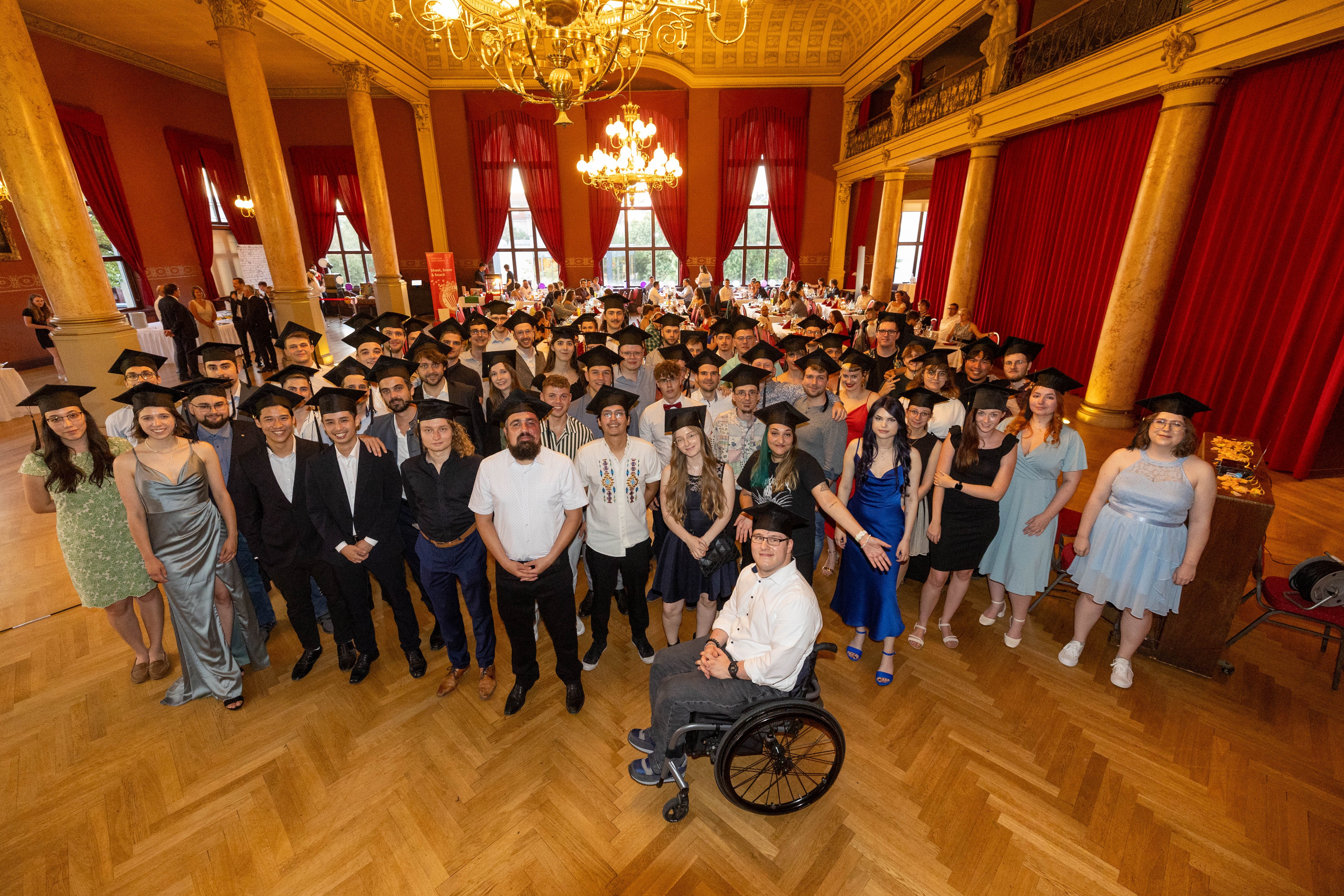 Gruppenbild der Absolventinnen und Absolventen im Ballhaus Watzke
