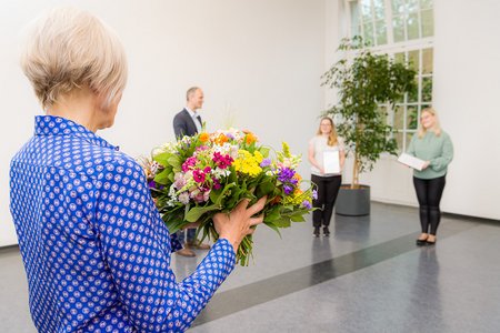 Frau Salchert übergibt Blumen