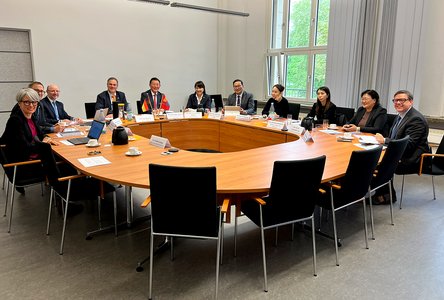 Menschen sitzen um einen Konferenztisch